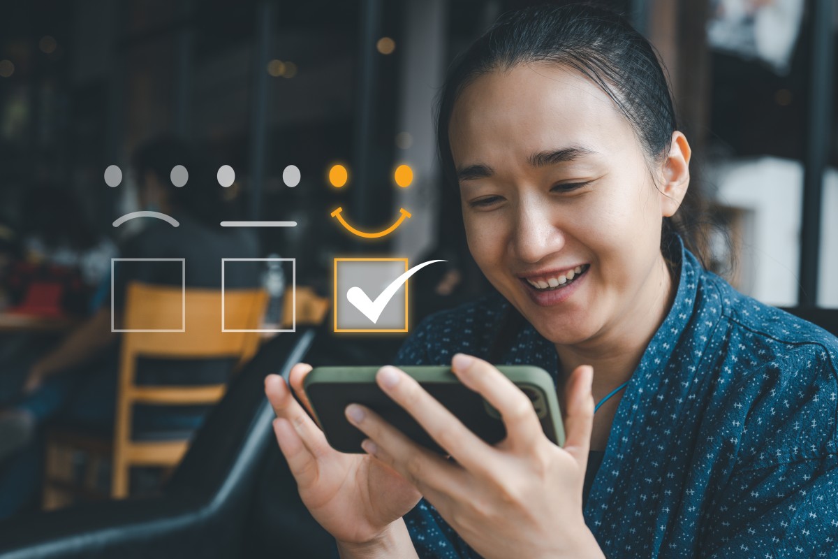 woman uses phone to provide brand survey response399081940